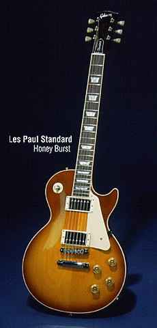 The Gibson Les Paul Signature Guitar - This one in honeyburst, with perl block inlays, cream binding and Gibson's Classic PAF (Patent Applied For) humbucker pickups. Chrome Hardware, cream pickguard. Standard version of the Guitar.